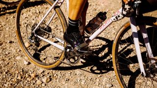 Person wearing the Rapha Explore Shoes on a gravel bike