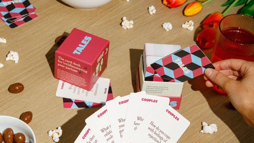 The Tales card game being played on Valentines day with flowers and chocolate surrounding the scene