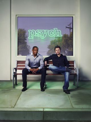 a promo shot of psych of two men sitting on a bench outside of a business with psych in neon letters