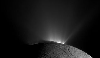Cassini image of Enceladus' geysers blasting material from the moon's subsurface ocean into space.