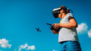 Best beginner drone: Image shows young boy flying a drone with FPV goggles