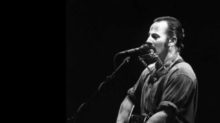 Bruce Spingsteen onstage in 1995 with an acoustic guitar