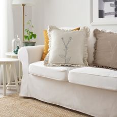 IKEA ÅKERNEJLIKA Cushion cover in a living room on a white sofa