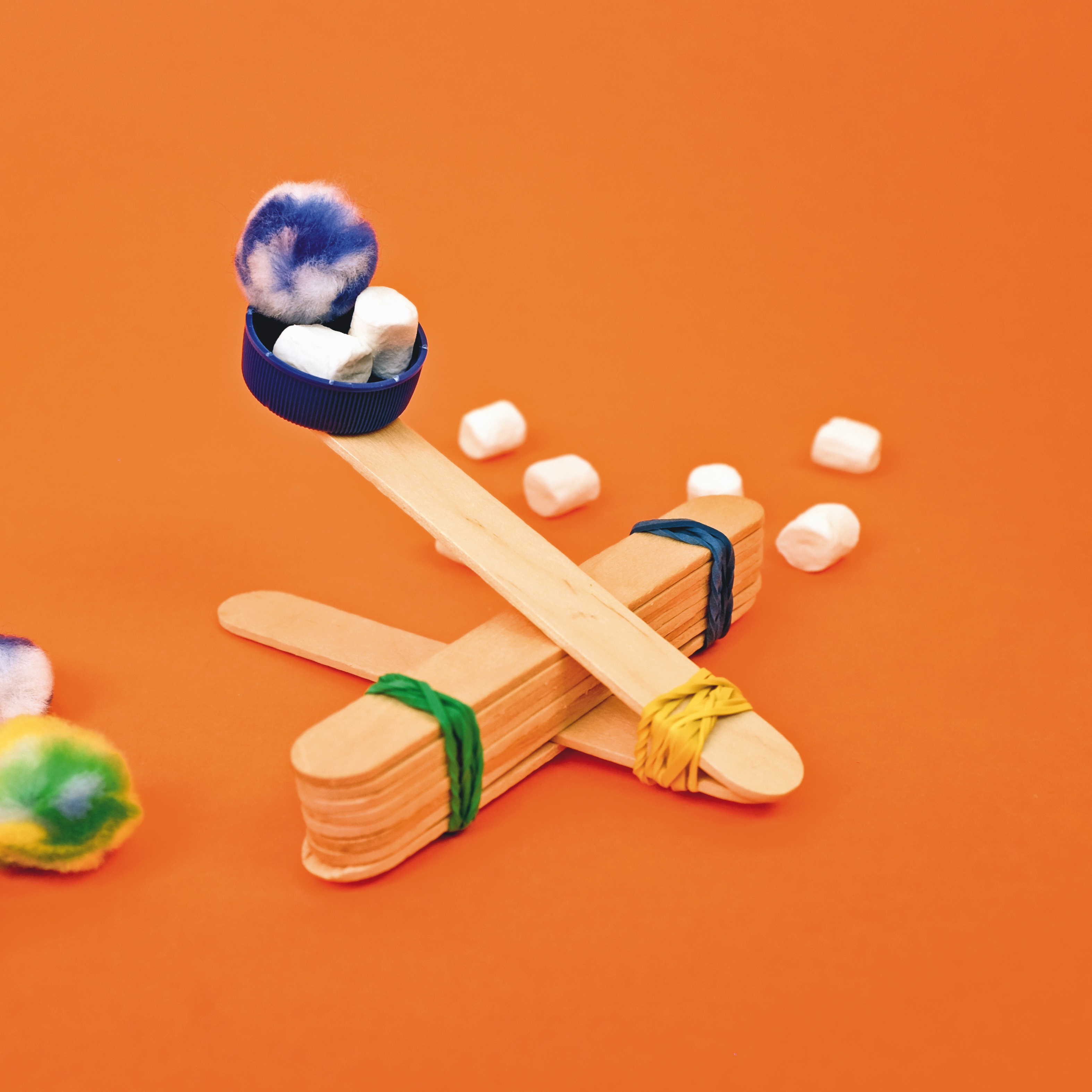 catapult made out of lolly sticks and a water bottle cap