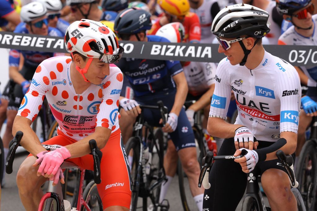 EF Education Easyposts US rider Neilson Powless wearing the best climbers polka dot dotted jersey L speaks with UAE Team Emirates Slovenian rider Tadej Pogacar wearing the best young riders white jersey R as they await the start of the 3rd stage of the 110th edition of the Tour de France cycling race 1935 km between AmorebietaEtxano in Northern Spain and Bayonne in southwestern France on July 3 2023 Photo by Thomas SAMSON AFP Photo by THOMAS SAMSONAFP via Getty Images