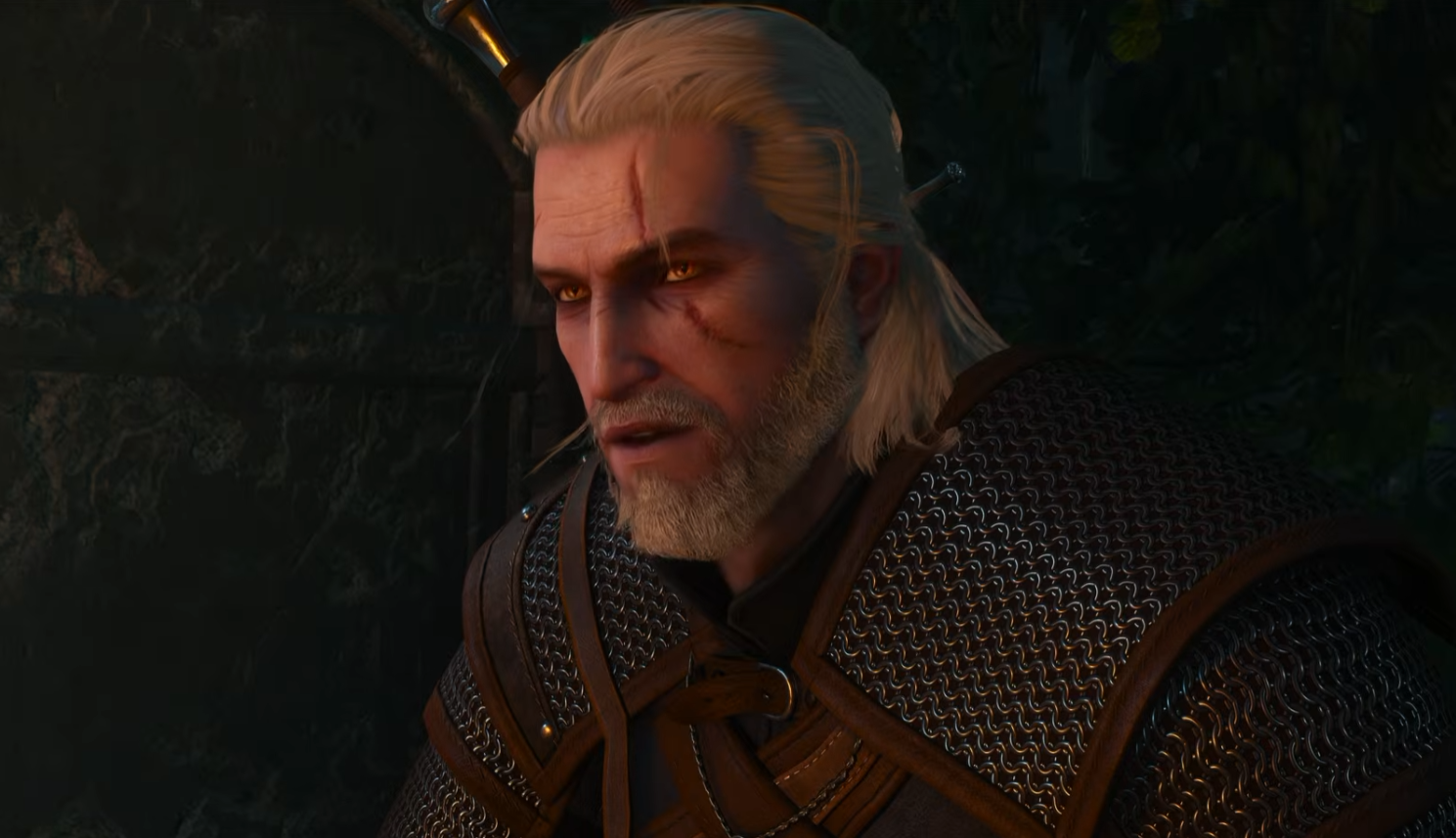 A still from the Witcher 3 Remastered reveal trailer showing Geralt in dim lighting.