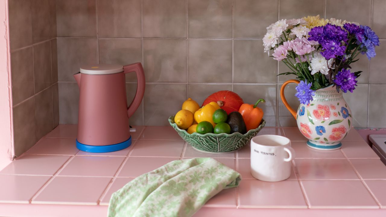 pink painted worktop with fruit bowl in kitchen