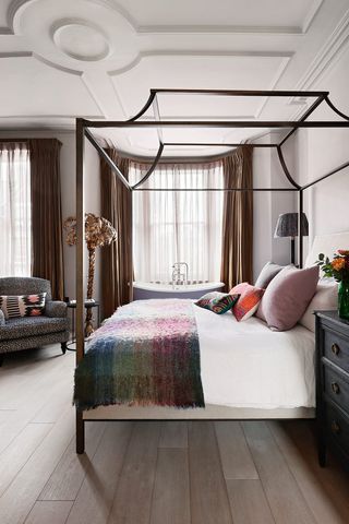 Canopy bed in large traditional bedroom