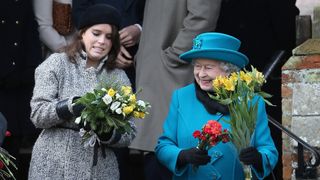 Queen Elizabeth II hands flowers to Princess Eugenie as they leave St Mary Magdalene Church