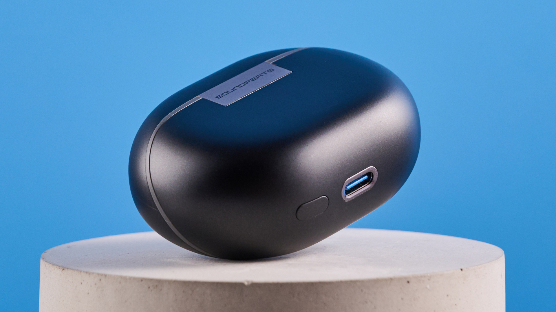 the soundpeats air5 pro earbuds in black and bronze with a black charging case and ear tips