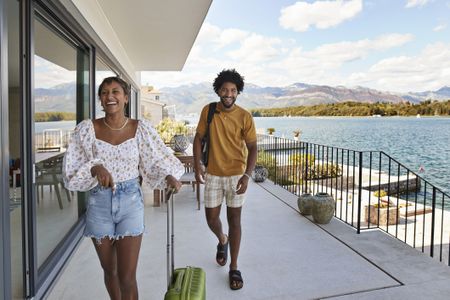 Couple walks up to vacation rental property on the beach.