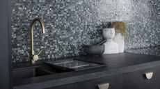 a big double kitchen sink in front of a mosaic green backsplash kitchen