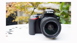 Image shows a front view of the Nikon D3500.