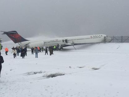 Passengers evacuate the plane