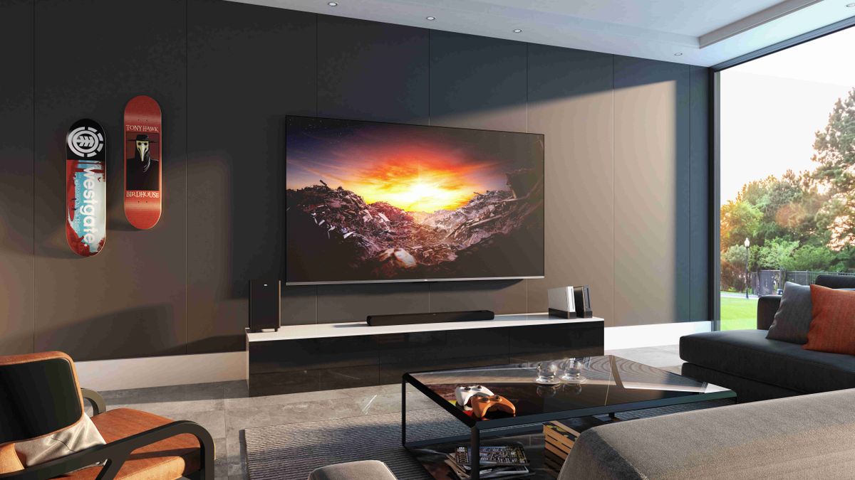 The TCL C73 4K QLED in a room next to two Wiis and and two Xbox controllers