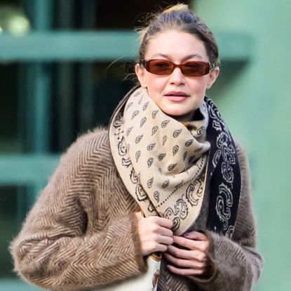 Gigi Hadid was spotted in New York wearing a wool coat, a Miu Miu bag, and fuzzy slippers