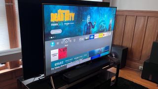 Amazon Fire TV Omni QLED shown from angle on TV stand