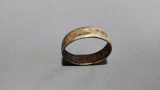 The metal ring found on the woman's left ring finger.