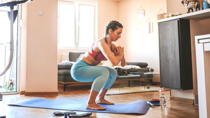a photo of a woman performing a squat 