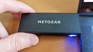 Netgear's Wi-Fi 6E USB adapter plugged into a laptop