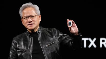 Nvidia CEO Jensen Huang holding the RTX Spark chip