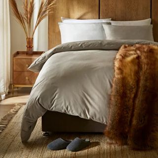 Dunelm cosy bedding cream colour in orange bedroom with faux fur throw 