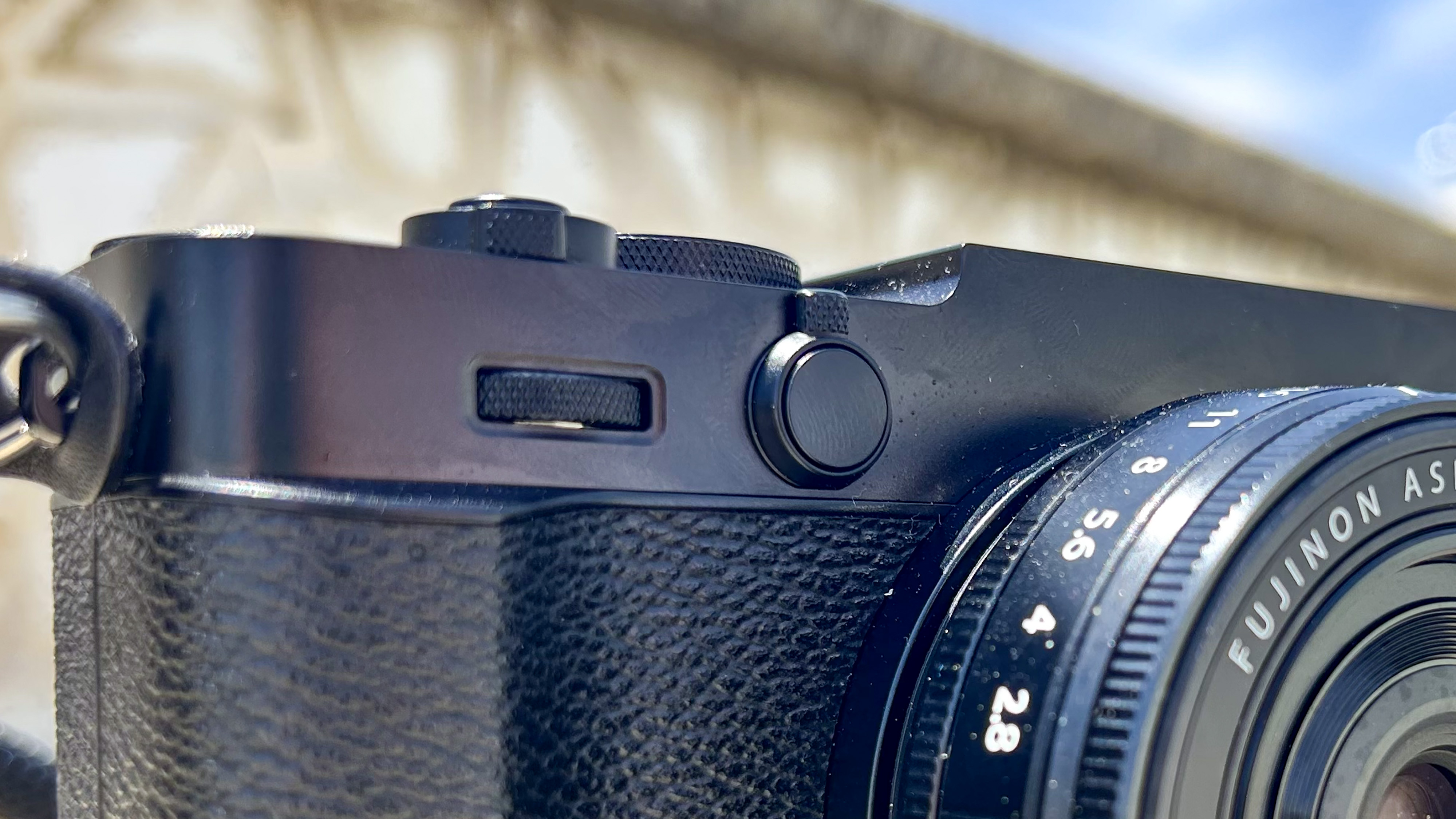 The front toggle used to switch between aspect ratios of new Fujifilm X-E5 film simulation camera.