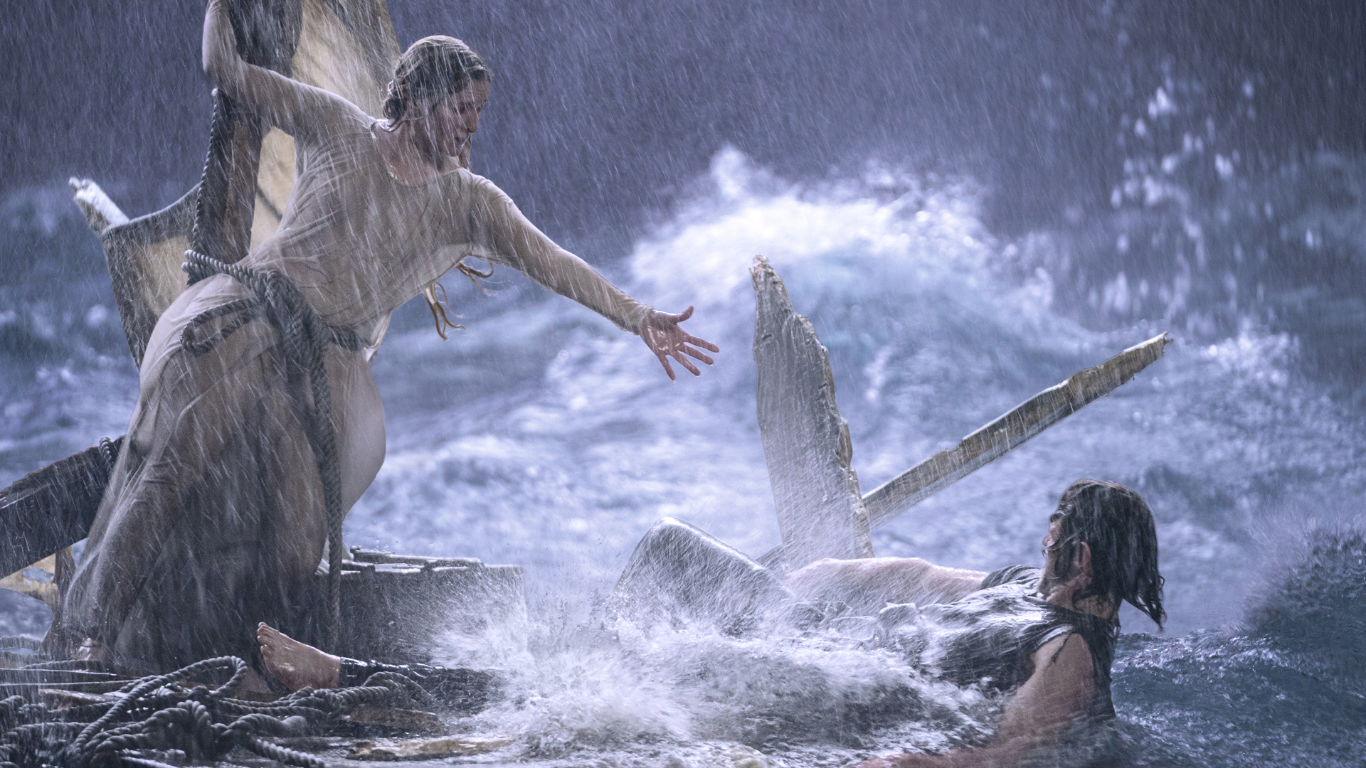 Morfydd Clark's Galadriel tries to help Charlie Vickers' Halbrand during a storm in The Rings of Power on Prime Video
