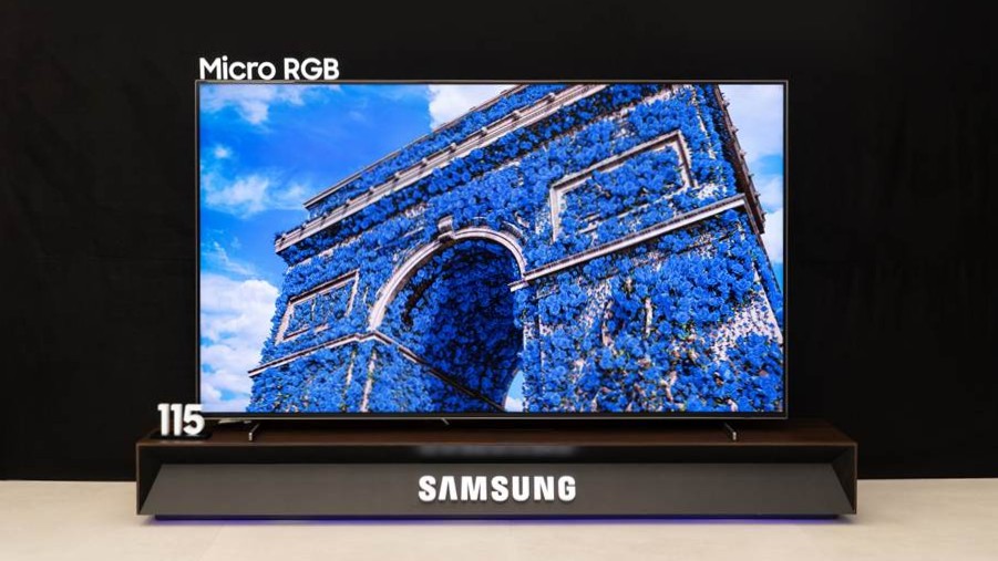 Samsung&#039;s 115 inch Micro RGB TV showing the Arc de Triomphe covered in blue flowers on screen.