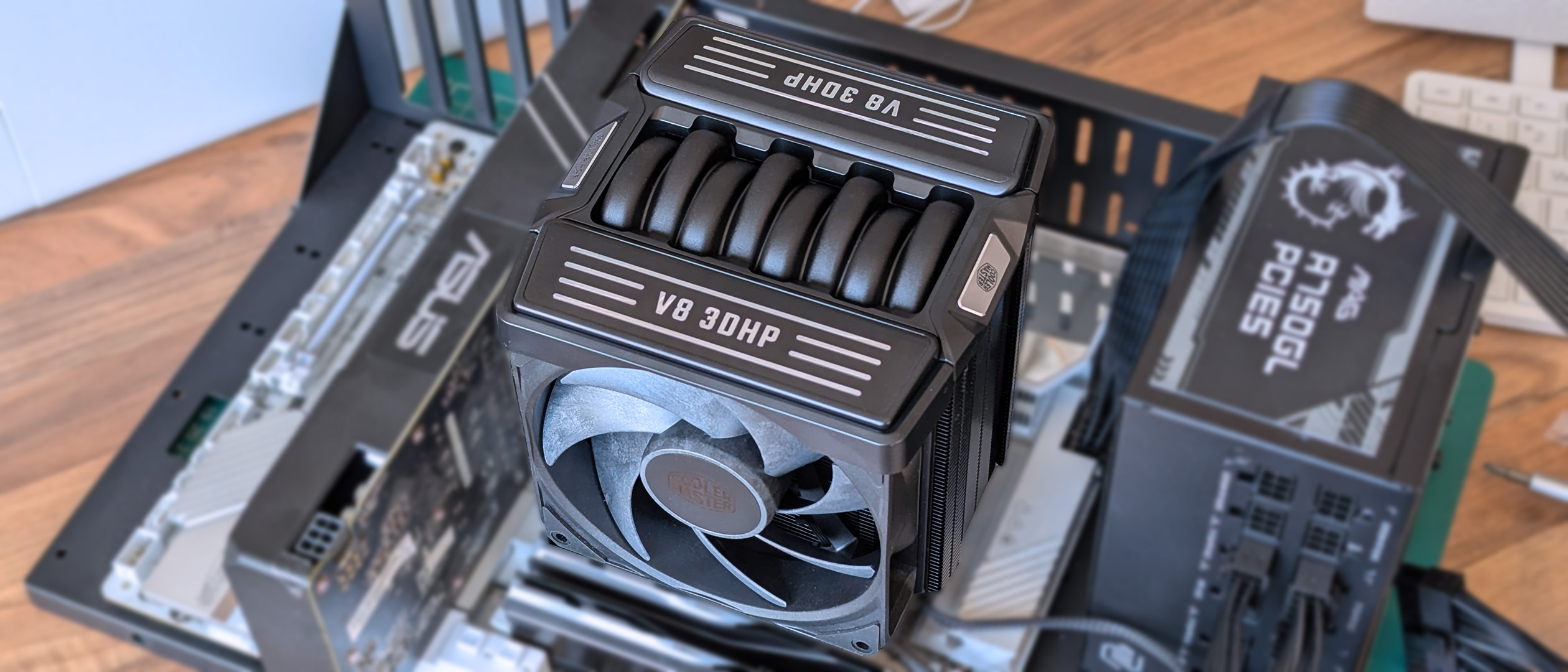 Cooler Master V8 ACE 3DHP CPU cooler installed onto a white motherboard mounted on a metallic test bench