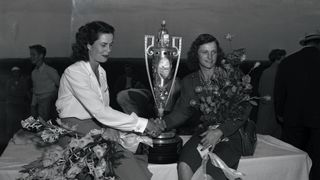 Mrs. Babe Didrikson Zaharias is congratulated by Mrs Clara Sherman after she took the cup for winning the 1946 Women's National Amateur Golf Championship