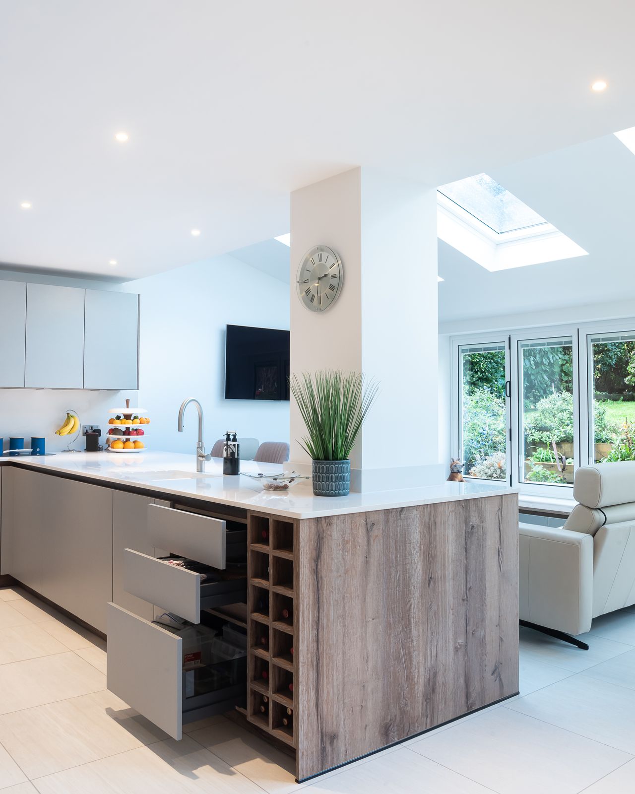 A kitchen with a peninsula that offers storage, cleaning and a place to chop veggies