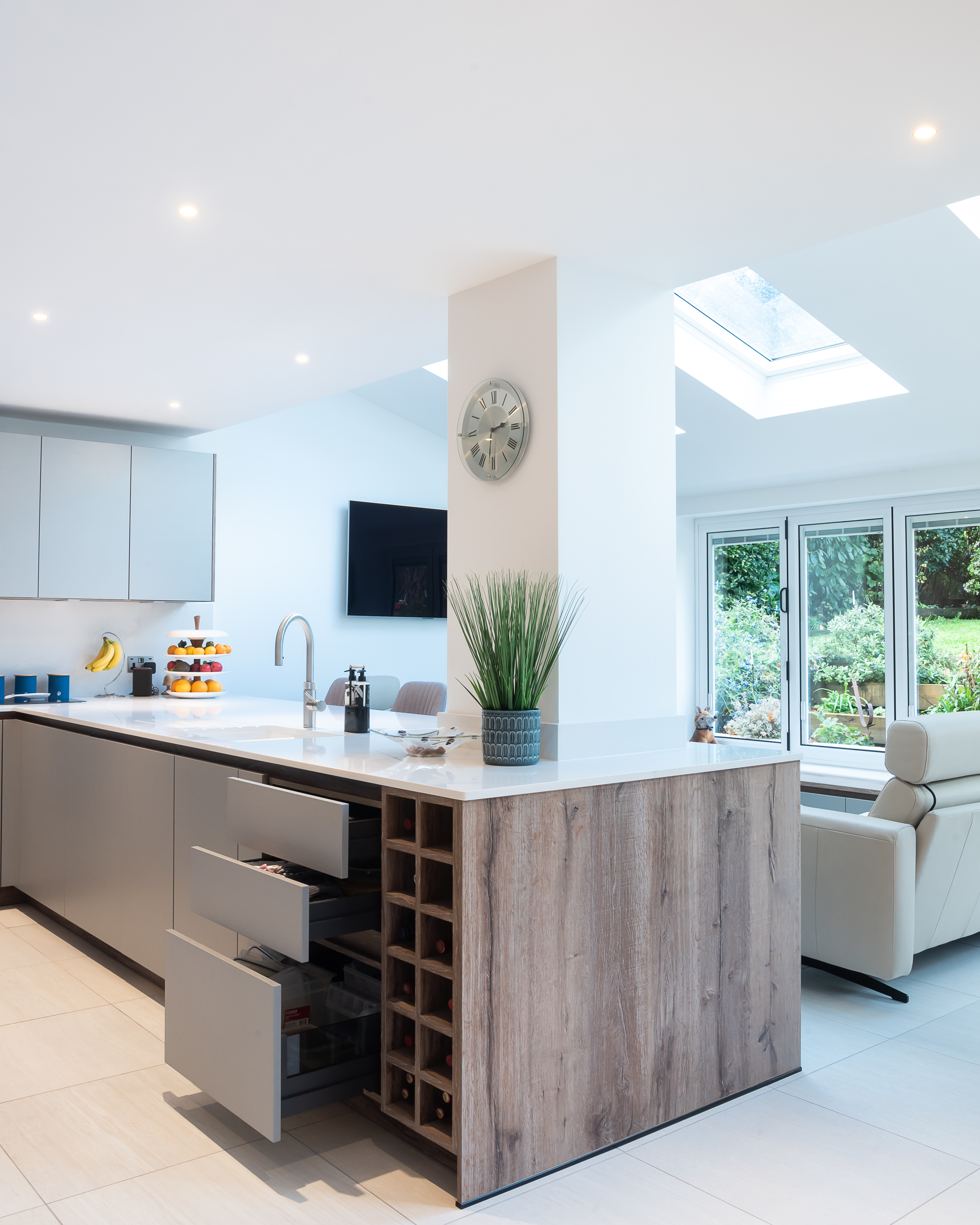 A kitchen with a peninsula that offers storage, cleaning and a place to chop veggies 