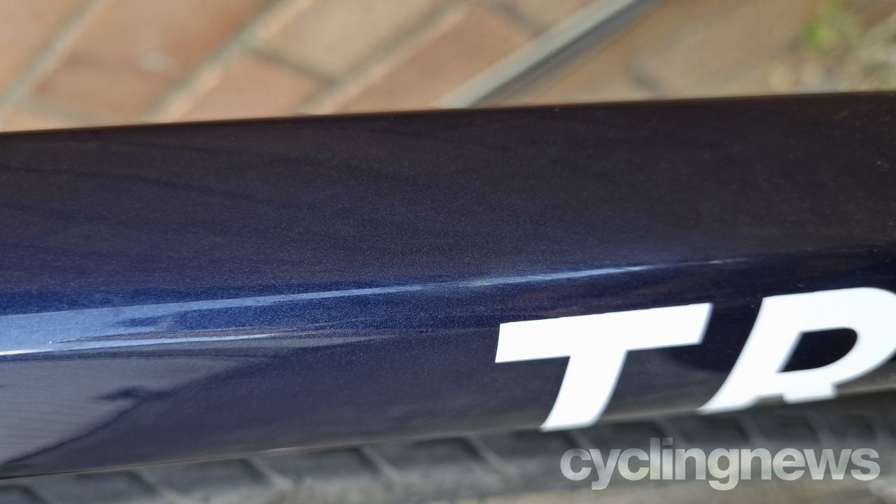 A close up of the dark blue metallic paint on the Triban bike