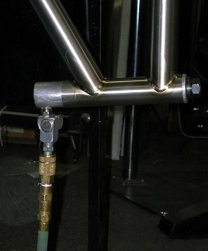 Oxygen, nitrogen, and hydrocarbons are the three most damaging elements to a molten titanium weld bead. Argon gas is used to purge these elements and ensure the integrity of the weld.