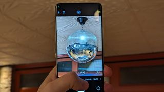 The Xiaomi Redmi Note 13 Pro Plus takign a photo of a disco ball in dim lighting