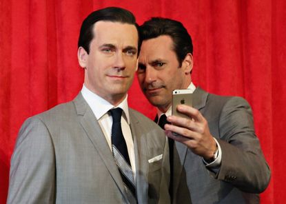 Jon Hamm takes a selfie with his wax figure.