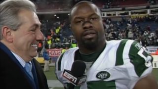 Bart Scott speaks with Sal Paolantonio on the field after a game.