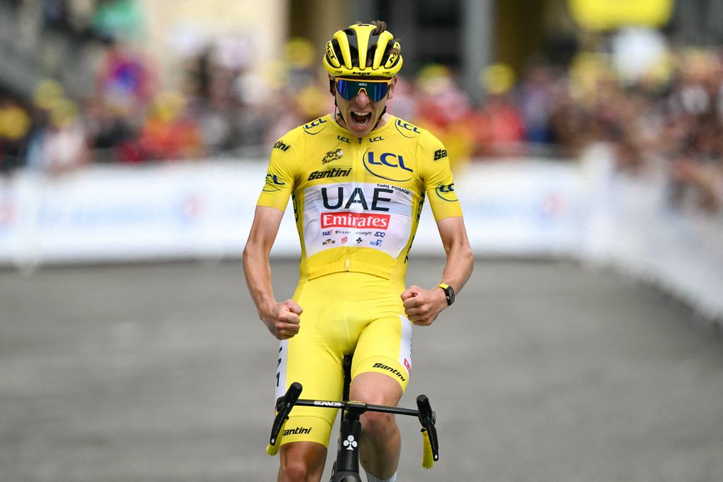 UAE Team Emirates team's Slovenian rider Tadej Pogacar wearing the overall leader's yellow jersey cycles to the finish line to win the 14th stage of the 111th edition of the Tour de France cycling race, 151,9 km between Pau and Saint-Lary-Soulan Pla d'Adet, in the Pyrenees mountains in southwestern France, on July 13, 2024. (Photo by Marco BERTORELLO / AFP)