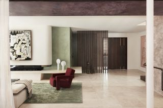 living room with mint green walls and rug, purple ceiling and red armchair