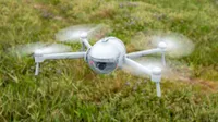 The PowerVision PowerEgg X drone in full flight over a field during testing