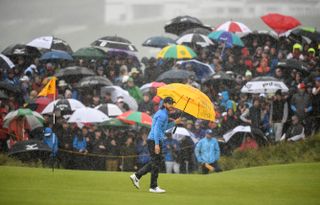 Tommy Fleetwood holds an umbrella at the 2019 Open Championship