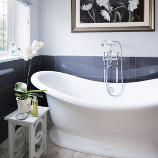 bathroom with bathtub and walled picture