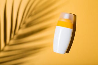 Suncream on a yellow backdrop for use in a level 4 heatwave