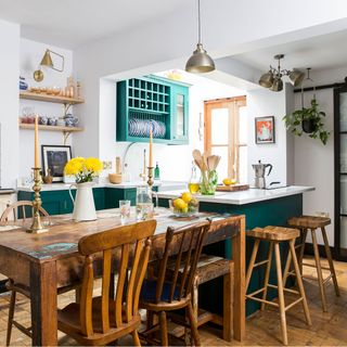 green kitchen with wooden table