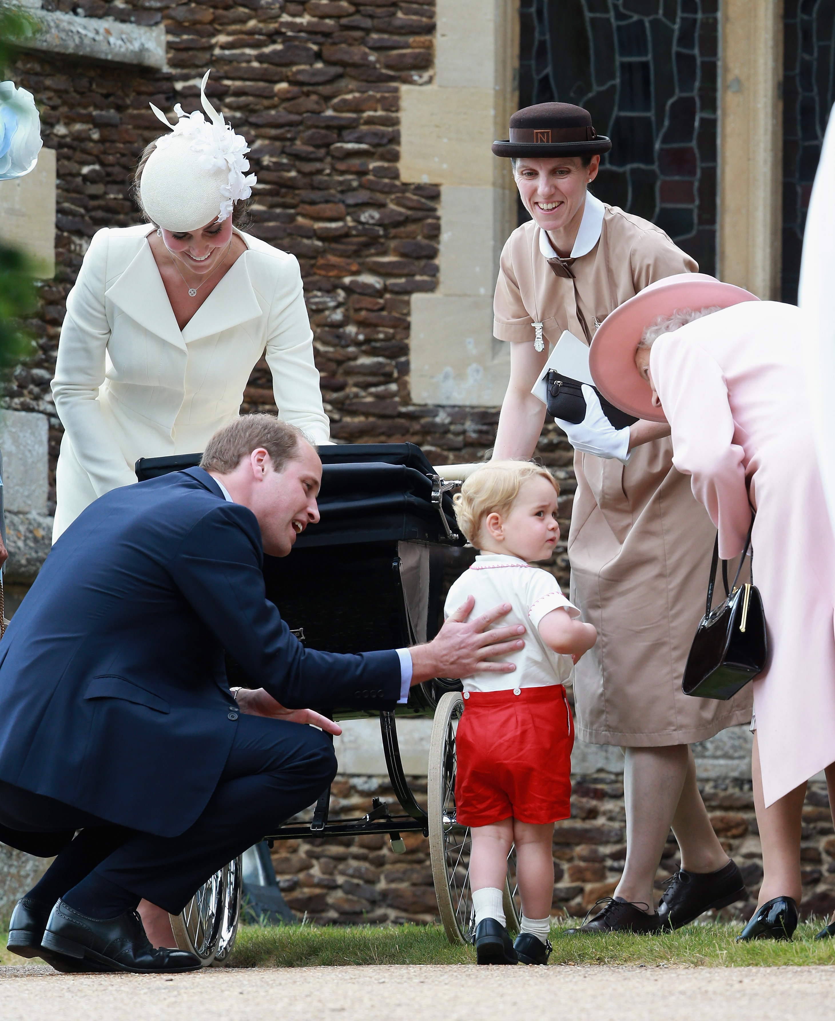 Princess Kate standing next to Nanny Maria, Prince William and Queen Elizabeth, who is leaning over to talk to Prince George at Princess Charlotte's christening