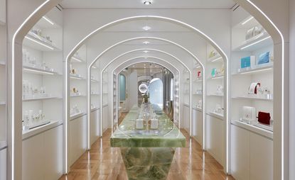 Dr. Barbara Strum London boutique and spa with green onyx display table and white shelves 