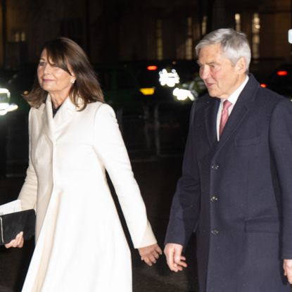 Carole Middleton wears a white coat and is joined by Pippa Middleton in a black sparkly coat and their family members for Kate Middleton's Christmas carol concert