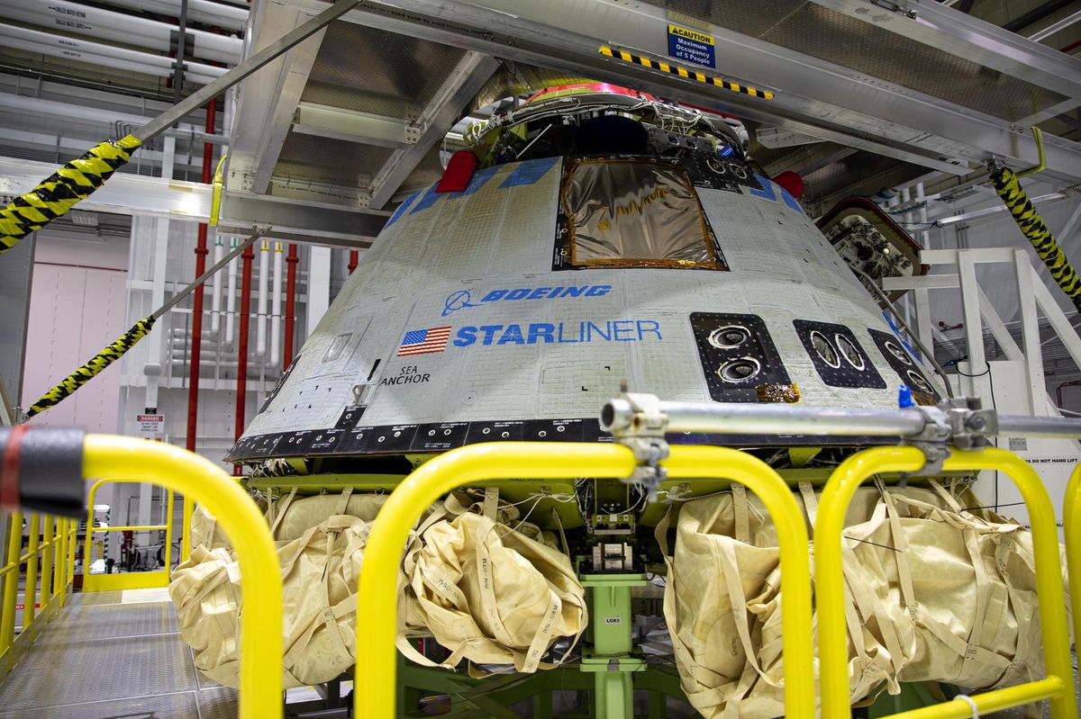 The Boeing CST-100 Starliner spacecraft is pictured at the company’s Commercial Crew and Cargo Processing Facility in Florida, undergoing inspection after its Orbital Flight Test.