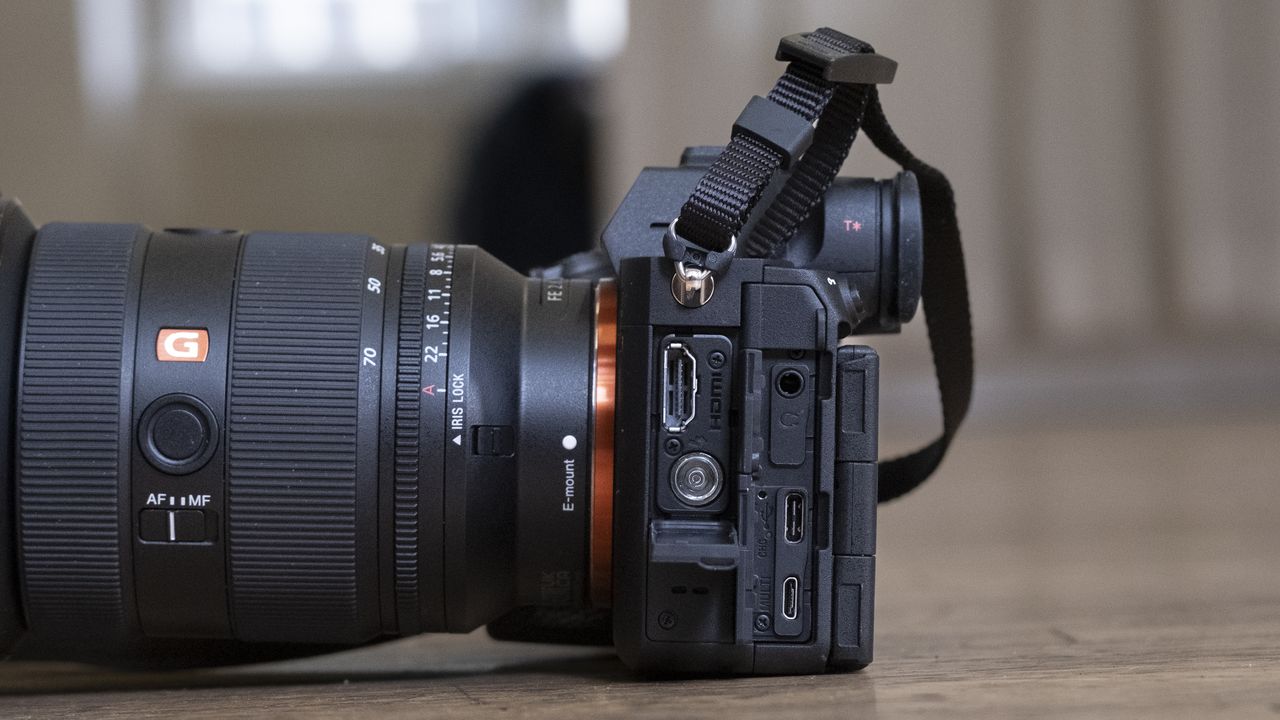 The Sony A7R V camera sitting on a wooden floor